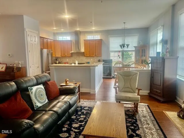 a living room with furniture and a dining table with kitchen view
