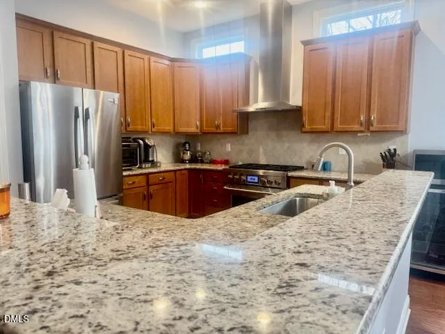 a kitchen with stainless steel appliances granite countertop a sink refrigerator and cabinets