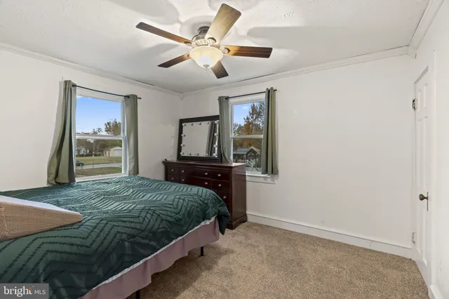a bedroom with a bed and a tv on the dresser