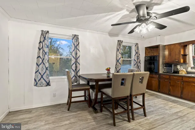 a view of a dining room with furniture wooden floor and chandelier