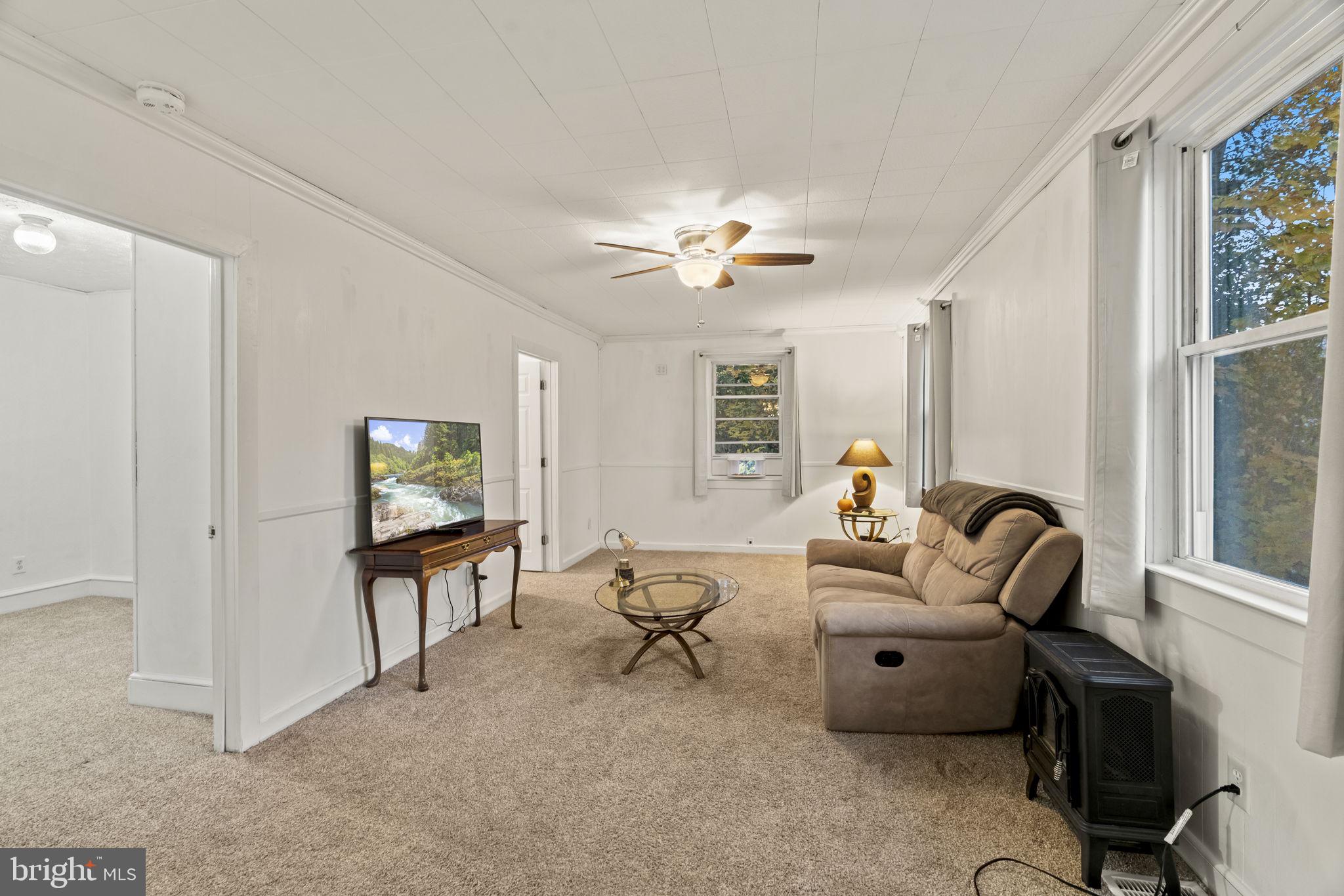 15 North Miller Avenue Carneys Point, NJ 08069 - Photo 10 of 18 a living room with furniture a ceiling fan and a window