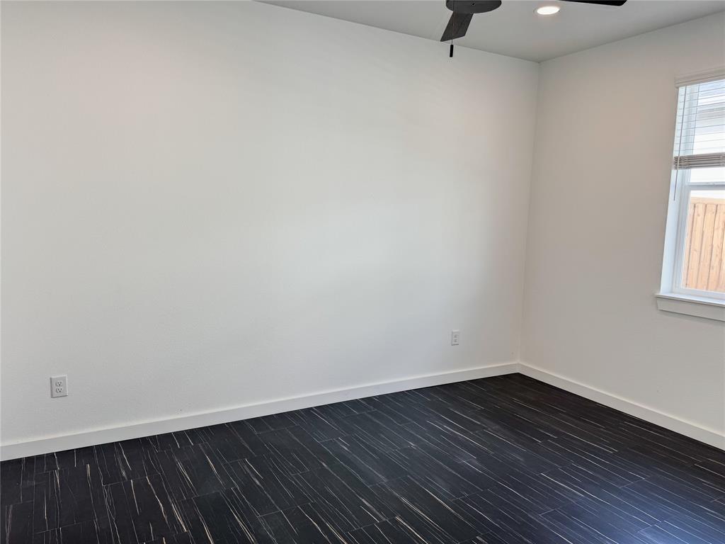 340 Lucy Road Greenville, TX 75402 - Photo 13 of 19 a view of an empty room with wooden floor and a window