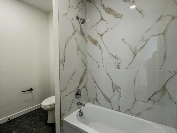 a bathroom with a toilet and a bathtub