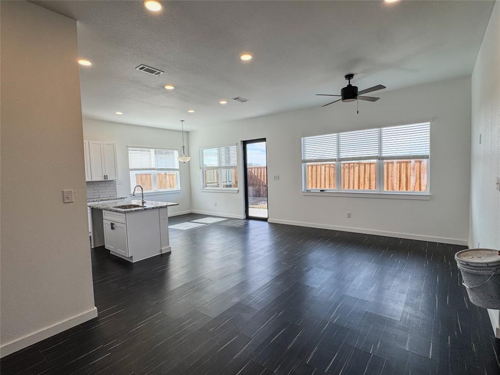 340 Lucy Road Greenville, TX 75402 - Photo 4 of 19 an empty room with wooden floor and windows