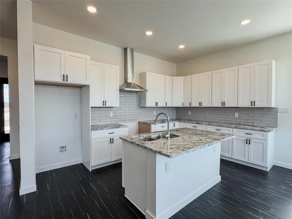a kitchen with stainless steel appliances granite countertop refrigerator sink and cabinets