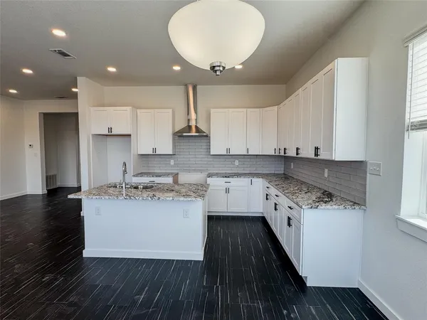 a kitchen with a sink stove and cabinets