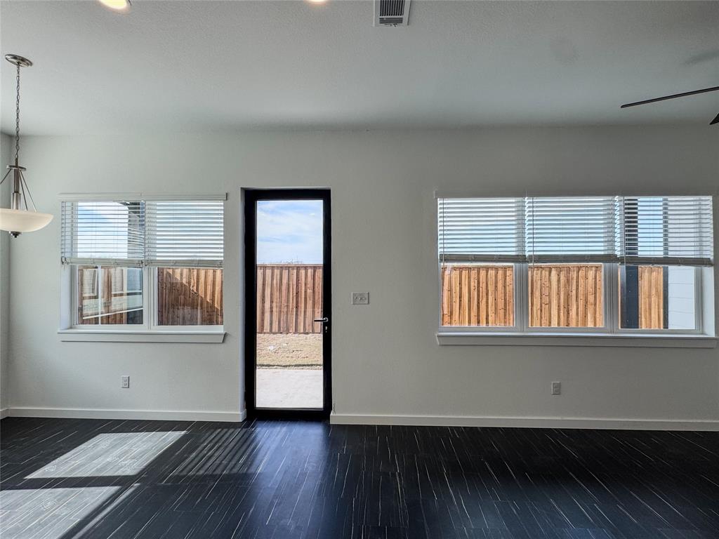 340 Lucy Road Greenville, TX 75402 - Photo 8 of 19 an empty room with wooden floor and windows