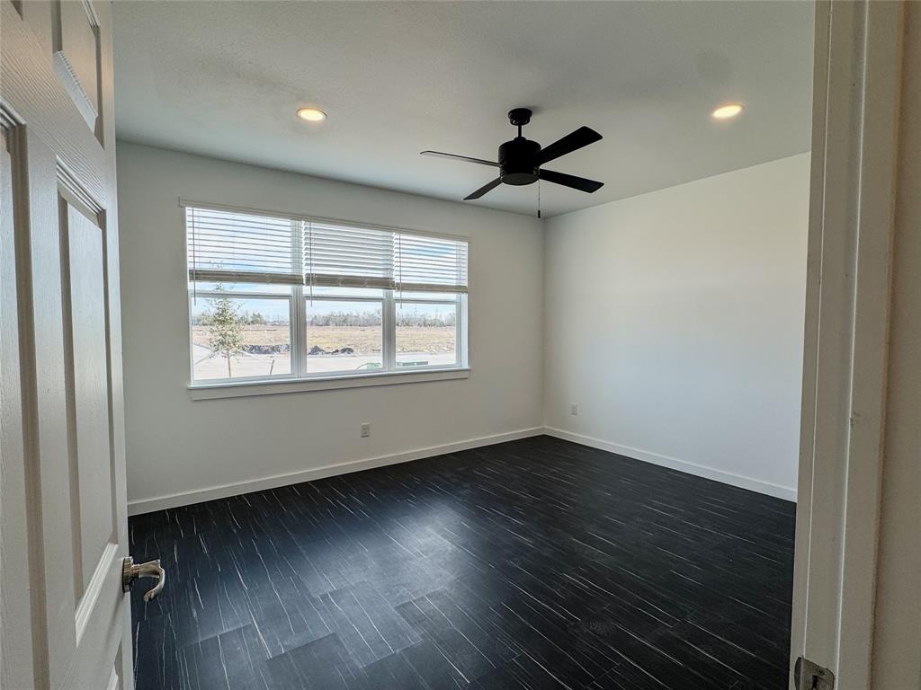 340 Lucy Road Greenville, TX 75402 - Photo 9 of 19 a view of an empty room with wooden floor and a window