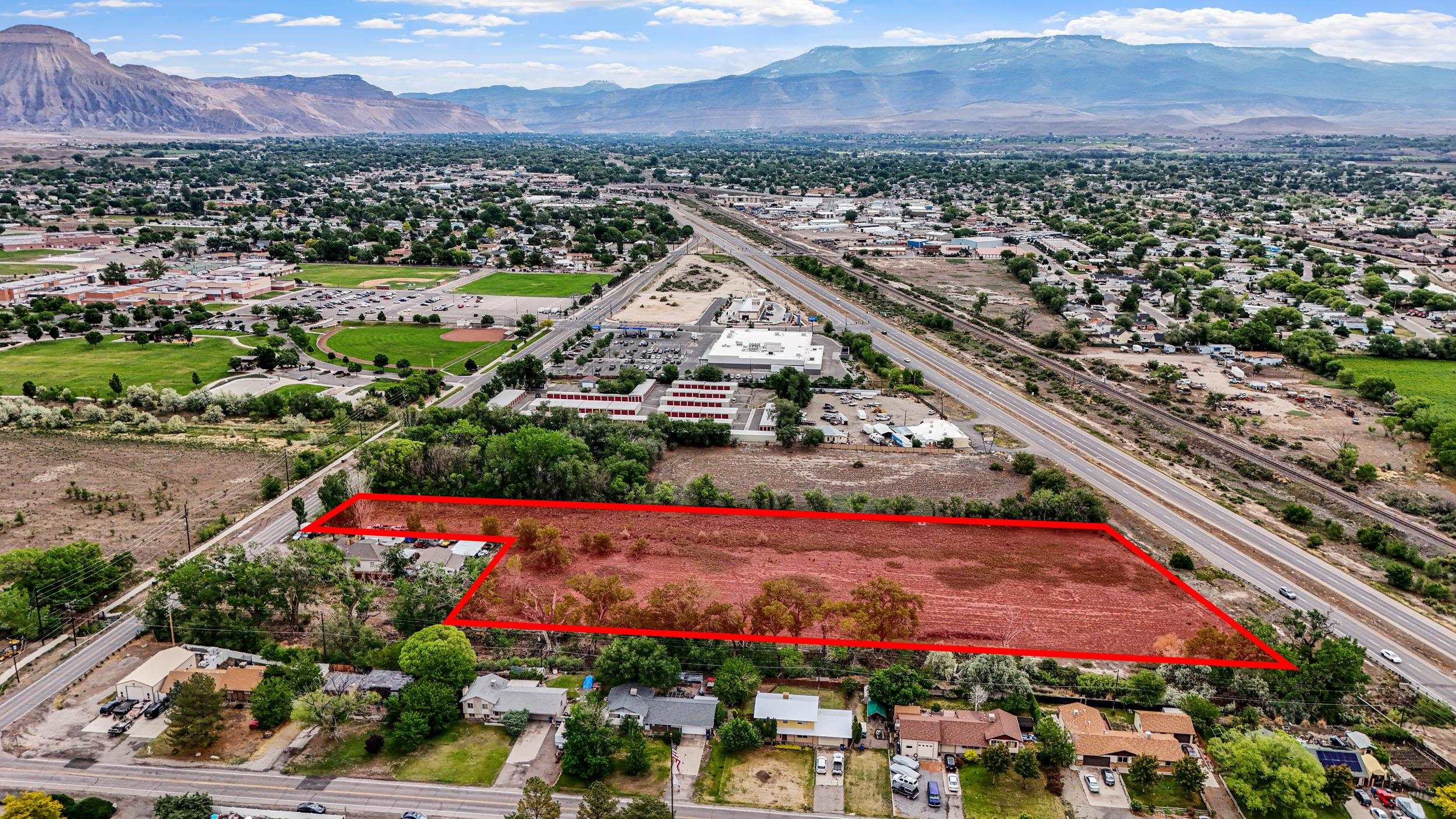 3105 East 1/2 Road Grand Junction, CO 81504 - Photo 6 of 6 an aerial view of a city with lots of residential buildings and mountain view in back