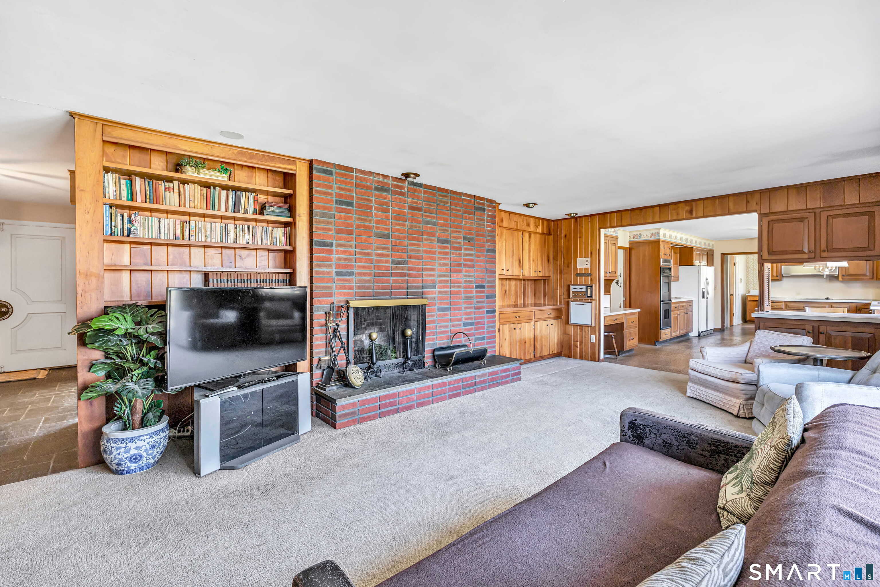 160 Sport Hill Road Easton, CT 06612 - Photo 18 of 40 a living room with furniture a flat screen tv and a fireplace