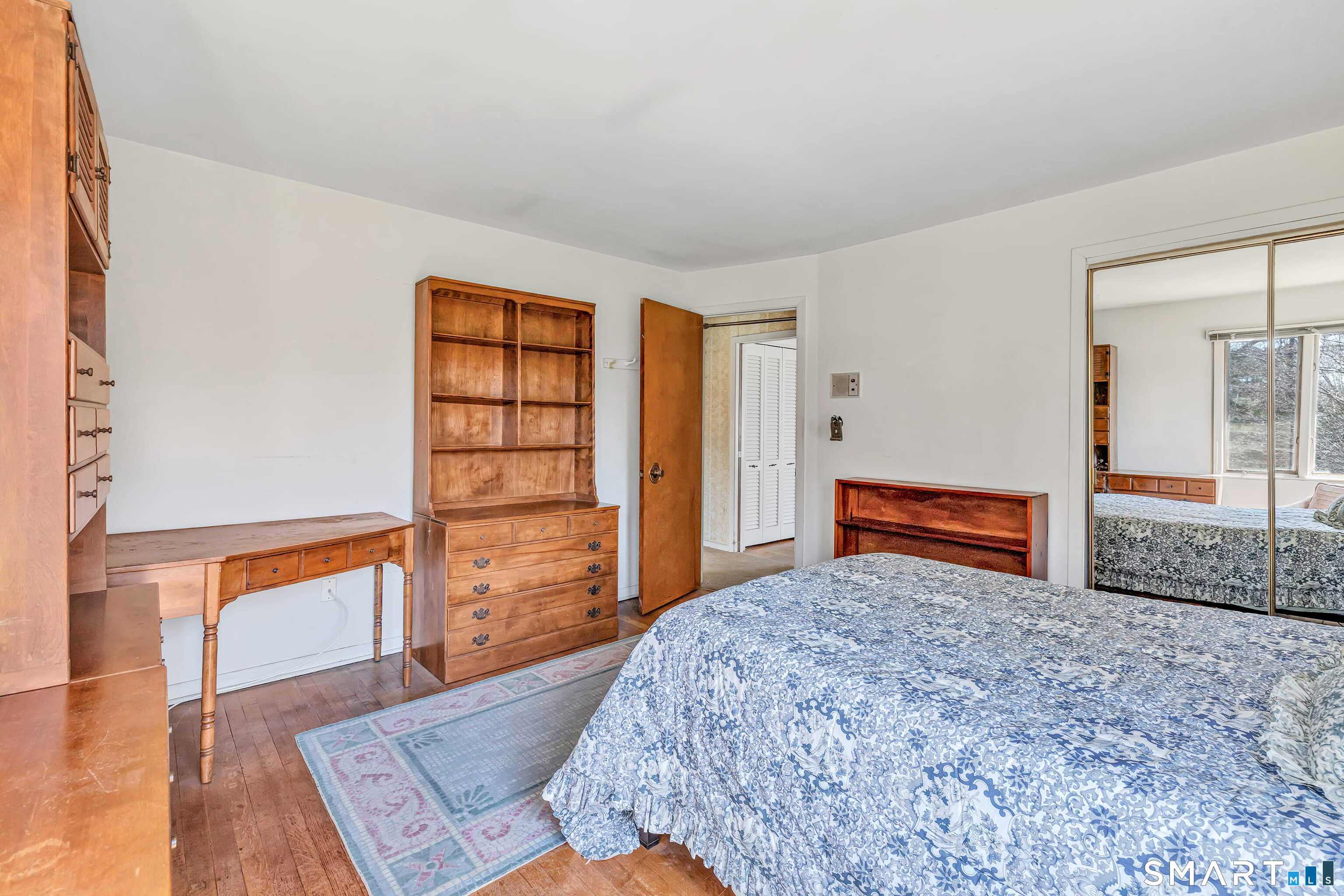 160 Sport Hill Road Easton, CT 06612 - Photo 28 of 40 a bedroom with a bed and a dresser with wooden floor