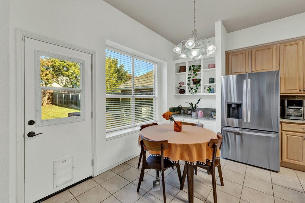 18 Equestrian Court Mansfield, TX 76063 - Photo 11 of 28 a kitchen with a refrigerator a table and chairs in it