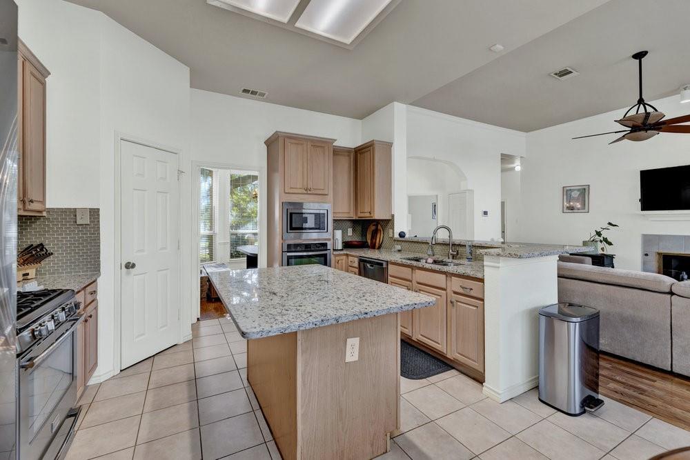 18 Equestrian Court Mansfield, TX 76063 - Photo 12 of 28 a kitchen with stainless steel appliances granite countertop a sink stove and refrigerator