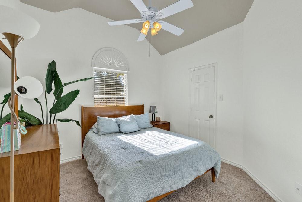 18 Equestrian Court Mansfield, TX 76063 - Photo 15 of 28 a bedroom with a bed and a chandelier