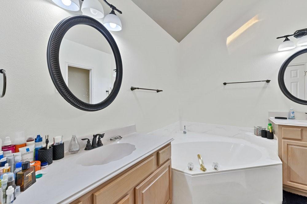 18 Equestrian Court Mansfield, TX 76063 - Photo 19 of 28 a bathroom with a sink and a mirror