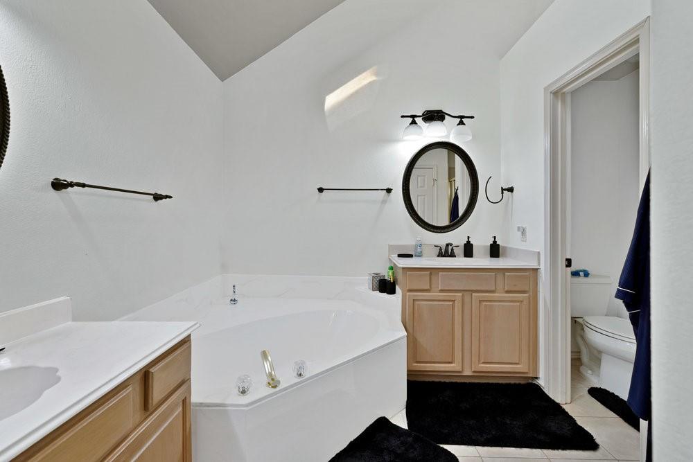 18 Equestrian Court Mansfield, TX 76063 - Photo 21 of 28 a bathroom with a sink and a mirror