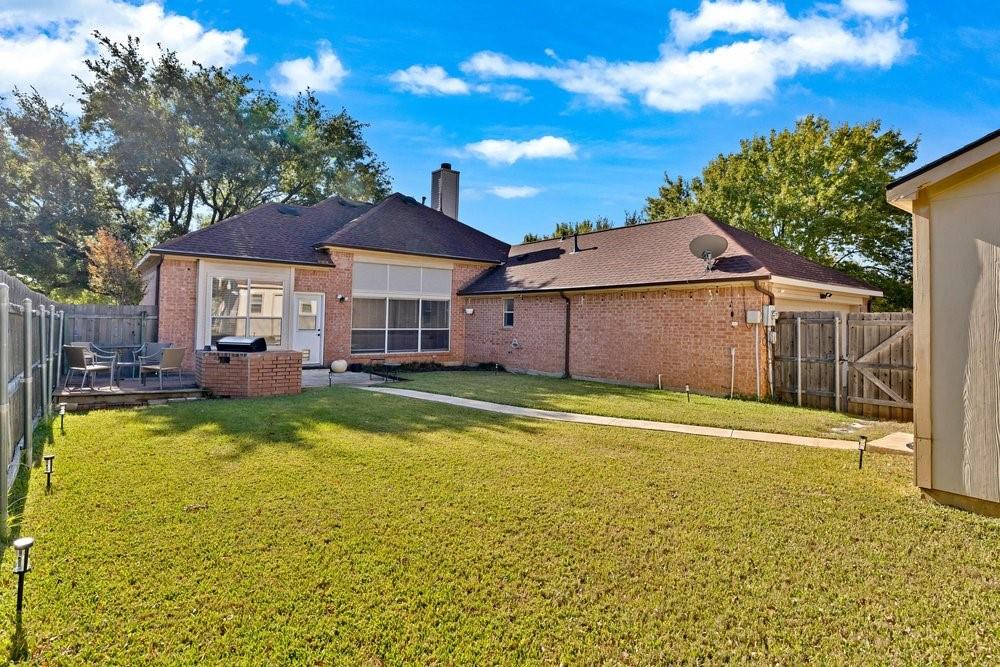 18 Equestrian Court Mansfield, TX 76063 - Photo 26 of 28 a view of a house with a swimming pool and a yard