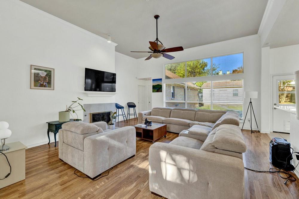 18 Equestrian Court Mansfield, TX 76063 - Photo 4 of 28 a living room with furniture a ceiling fan and a flat screen tv