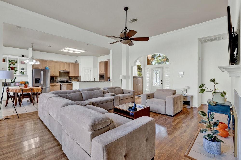 18 Equestrian Court Mansfield, TX 76063 - Photo 6 of 28 a living room with furniture kitchen view and a wooden floor