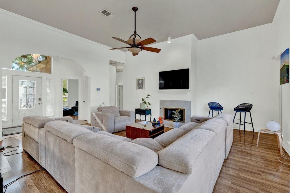 18 Equestrian Court Mansfield, TX 76063 - Photo 7 of 28 a living room with furniture a fireplace and a flat screen tv