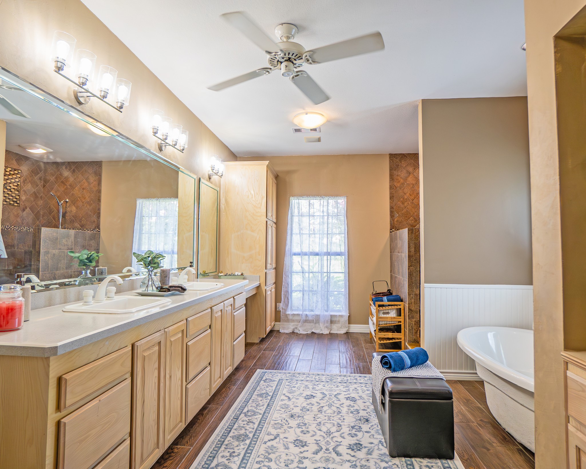 214 Williams Road Bay City, TX 77414 - Photo 41 of 48 a spacious bathroom with a double vanity sink a large mirror and a bathtub