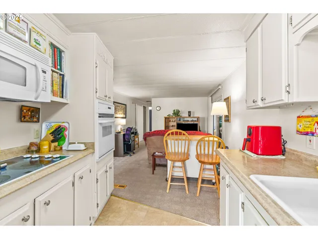 a kitchen with stainless steel appliances granite countertop a sink and cabinets