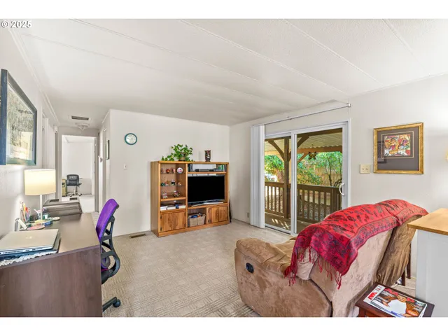 a bedroom with furniture and a flat screen tv