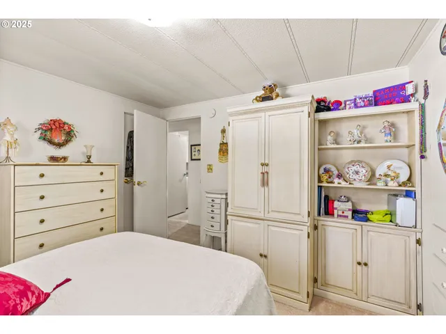 a utility room with closet dryer and baby crib