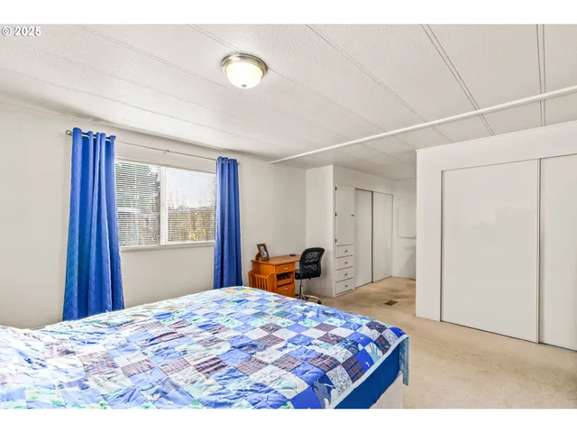 a bedroom with a bed and window