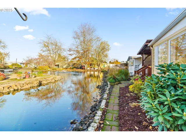 a view of a lake with a house in the background