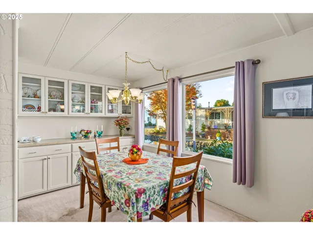 a dining room with furniture a chandelier and wooden floor