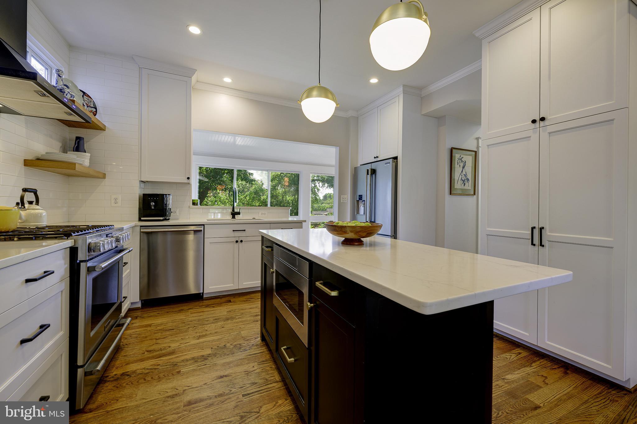 5710 Broad Branch Road Northwest Washington, DC 20015 - Photo 6 of 25 a kitchen with sink cabinets and wooden floor