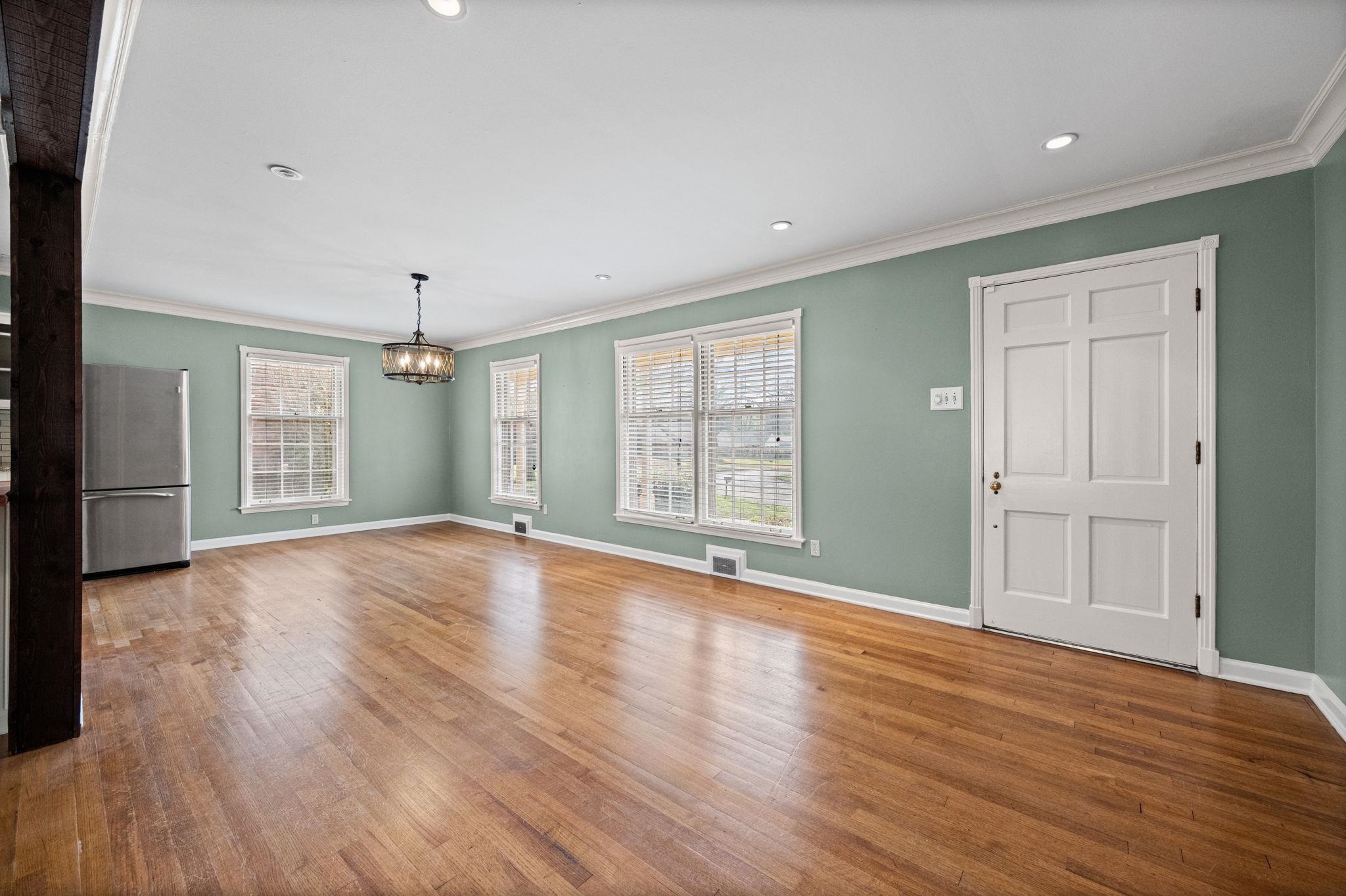 446 Rosser Road Memphis, TN 38120 - Photo 14 of 30 a view of an empty room with window and wooden floor