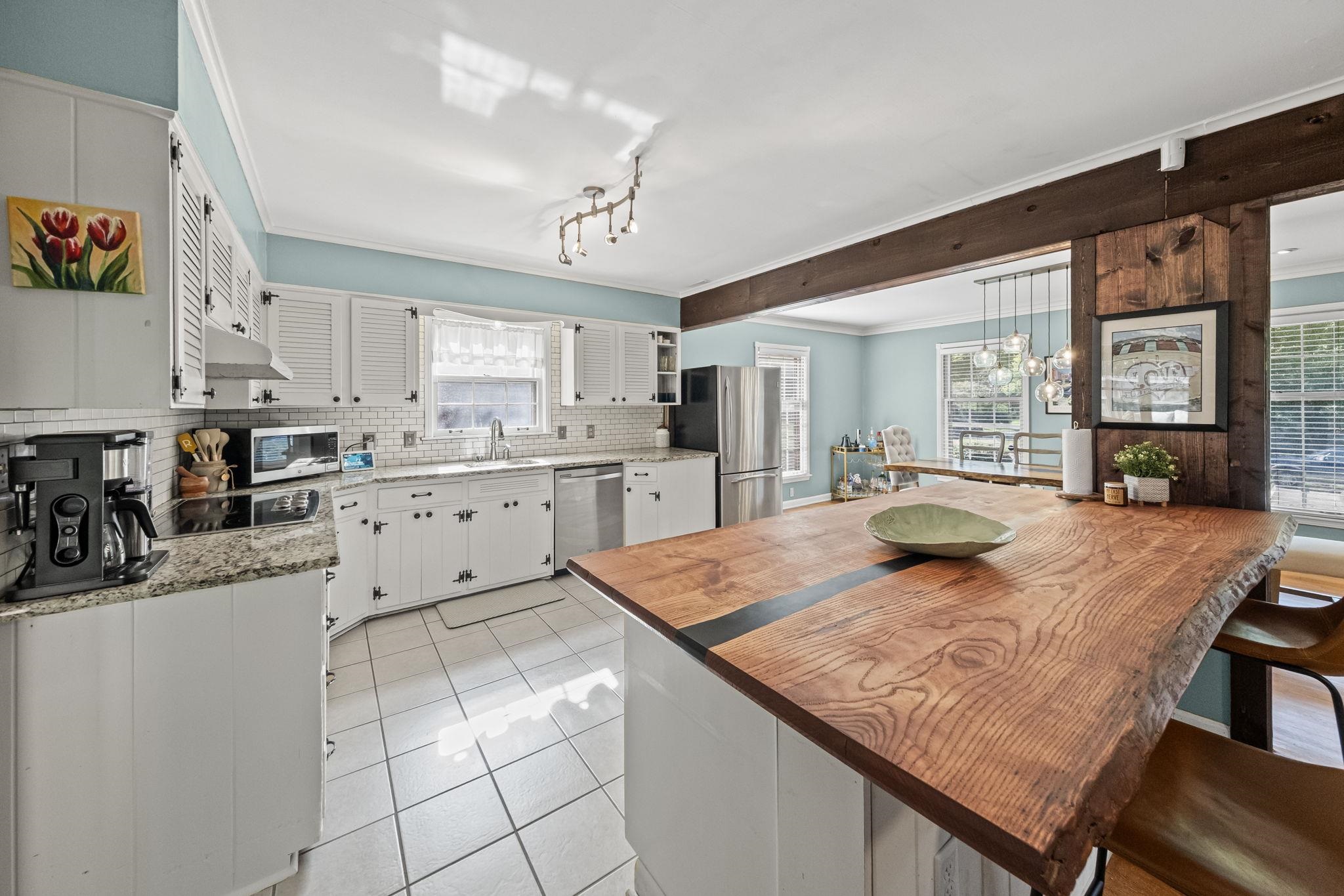 446 Rosser Road Memphis, TN 38120 - Photo 17 of 30 a kitchen with stainless steel appliances kitchen island granite countertop a sink and cabinets