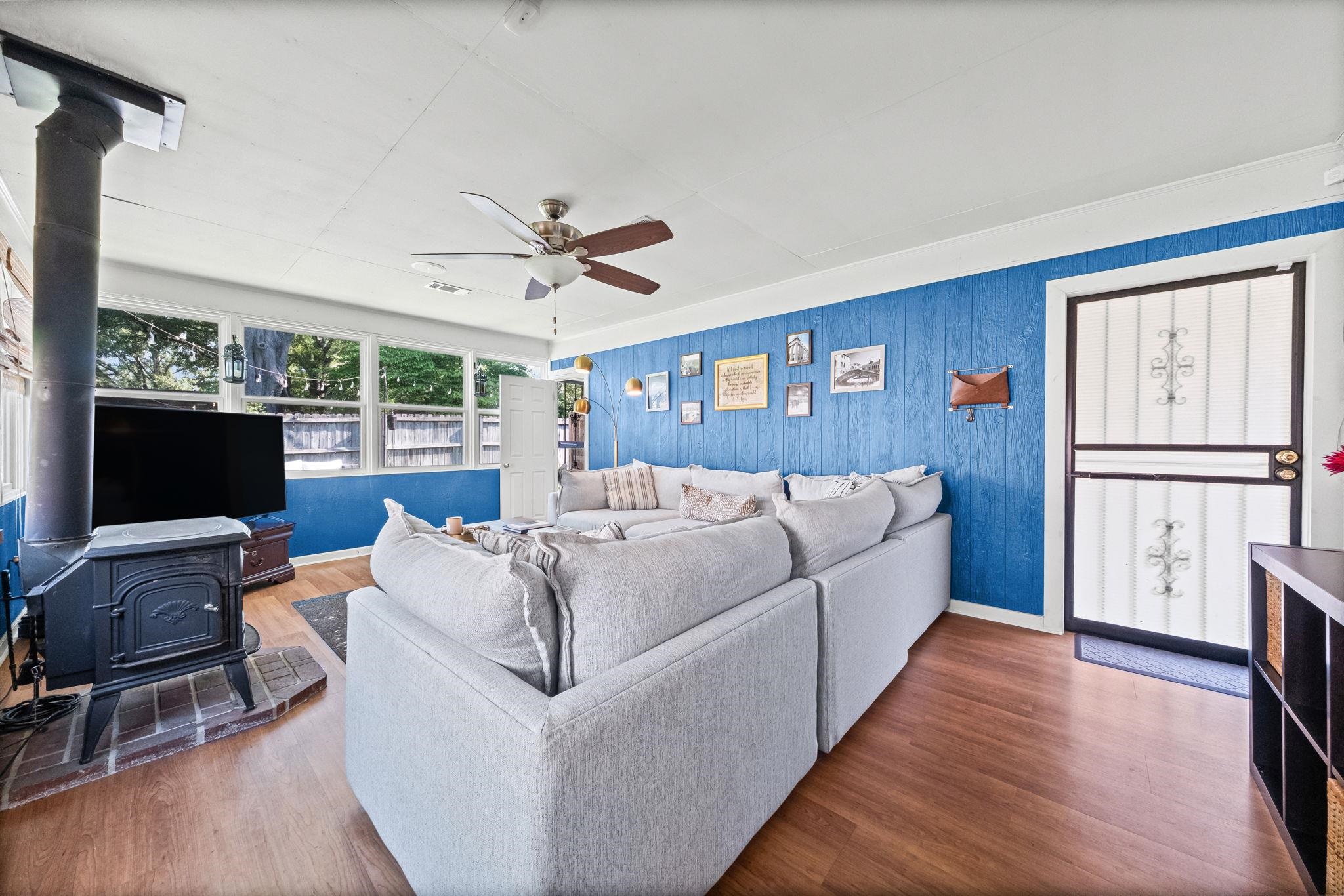 446 Rosser Road Memphis, TN 38120 - Photo 8 of 30 a living room with furniture a large window and a flat screen tv