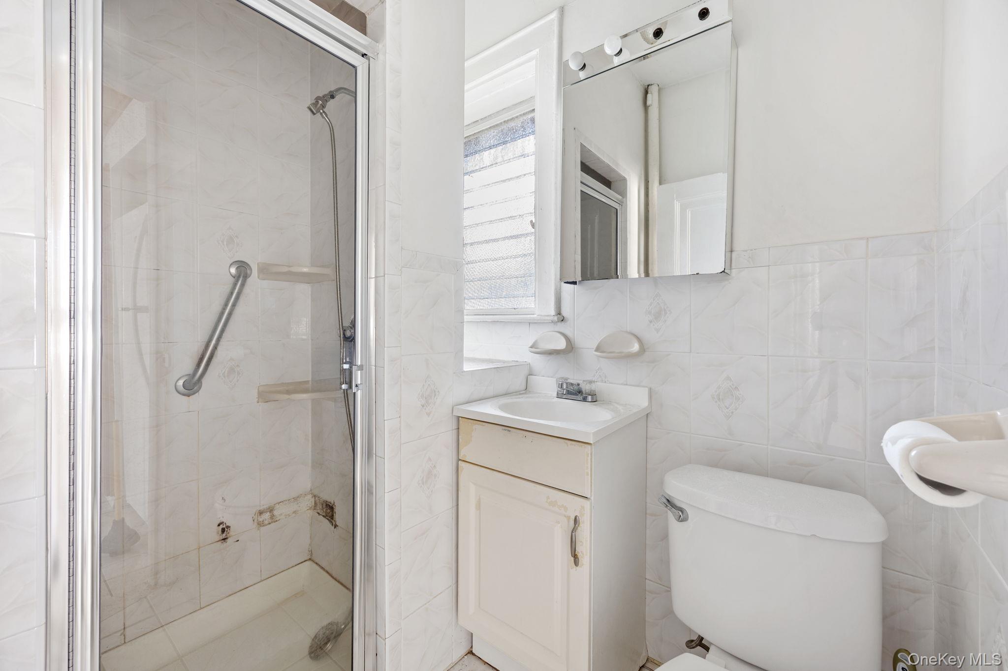 2109 Avenue R Brooklyn, NY 11229 - Photo 16 of 24 a bathroom with a granite countertop sink toilet and shower