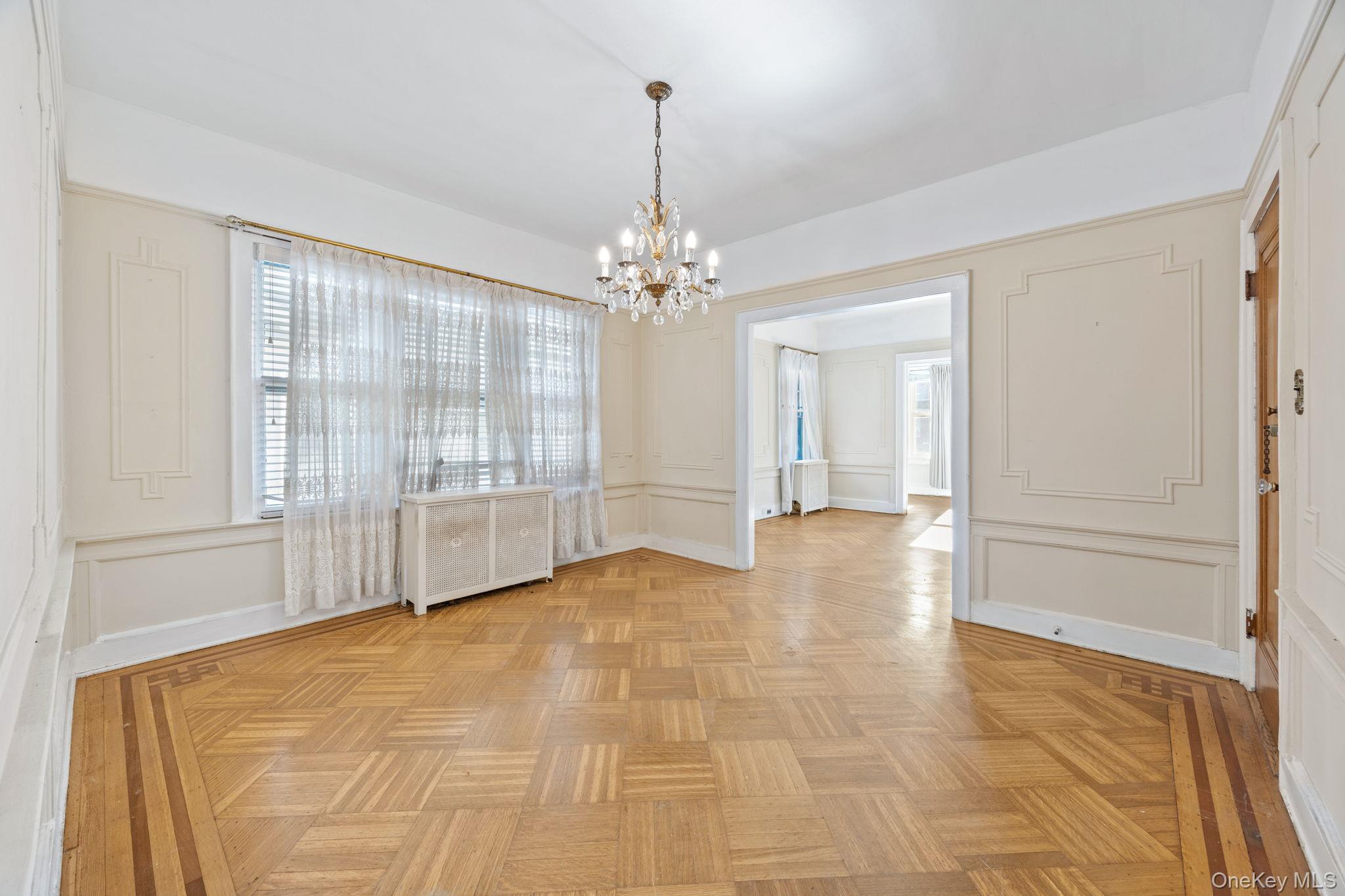 2109 Avenue R Brooklyn, NY 11229 - Photo 8 of 24 a view of an empty room with chandelier and a window