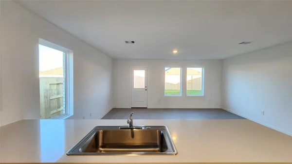 a view of kitchen with kitchen island wooden floor wooden floor and refrigerator