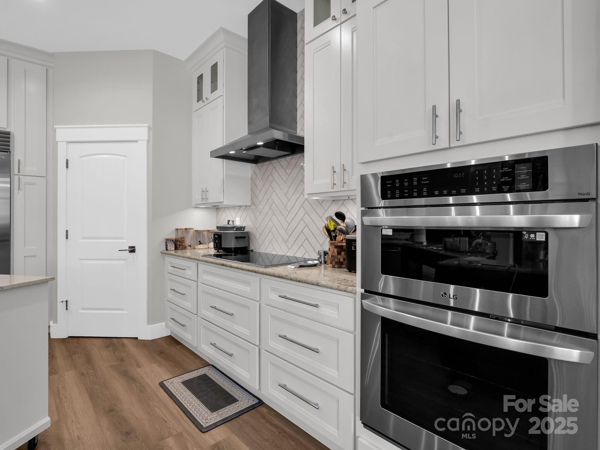 21 Walker Ridge Road Mill Spring, NC 28756 - Photo 11 of 48 a kitchen with stainless steel appliances granite countertop a stove a microwave and cabinets