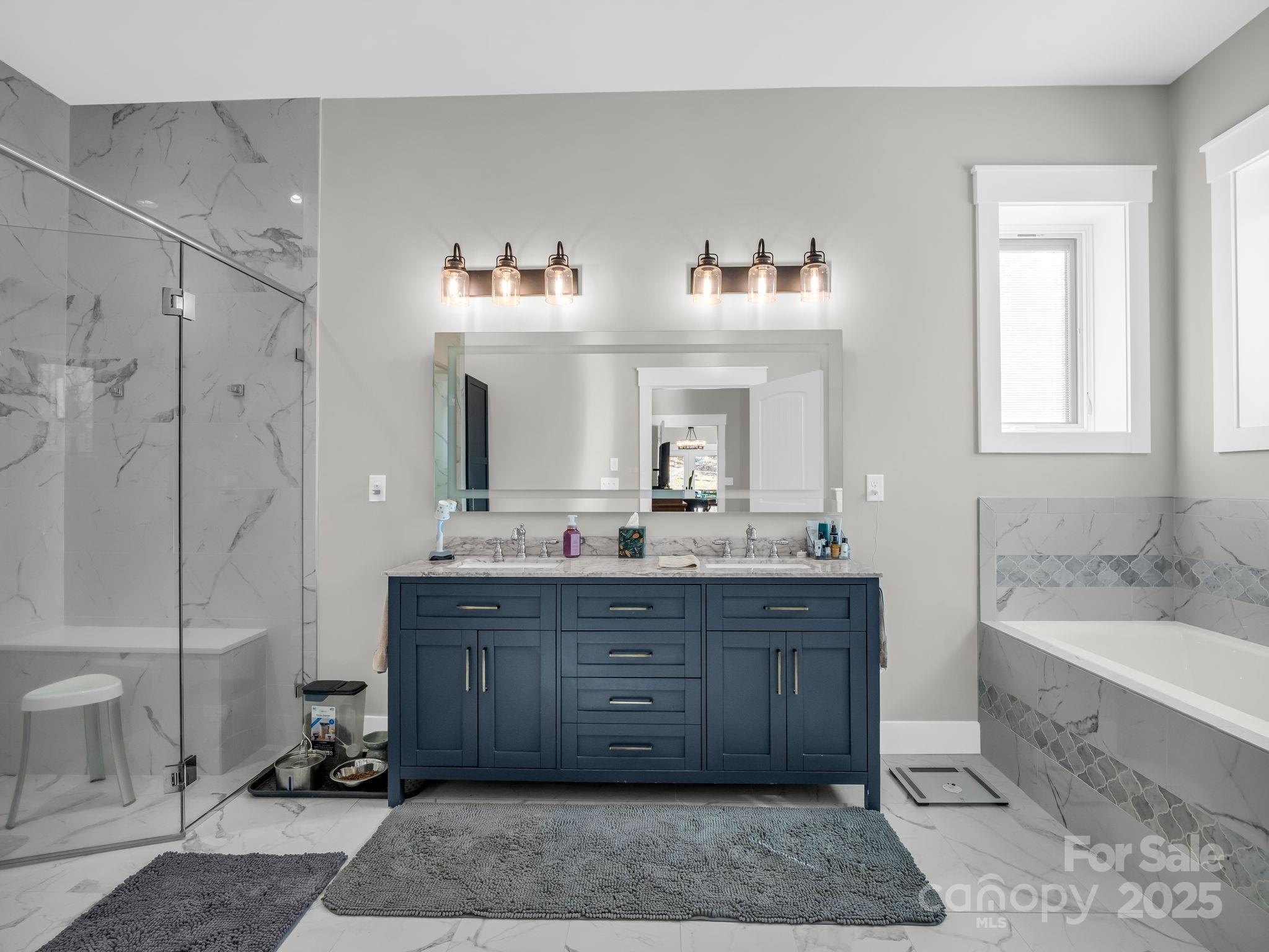21 Walker Ridge Road Mill Spring, NC 28756 - Photo 20 of 48 a spacious bathroom with a tub sink and mirror