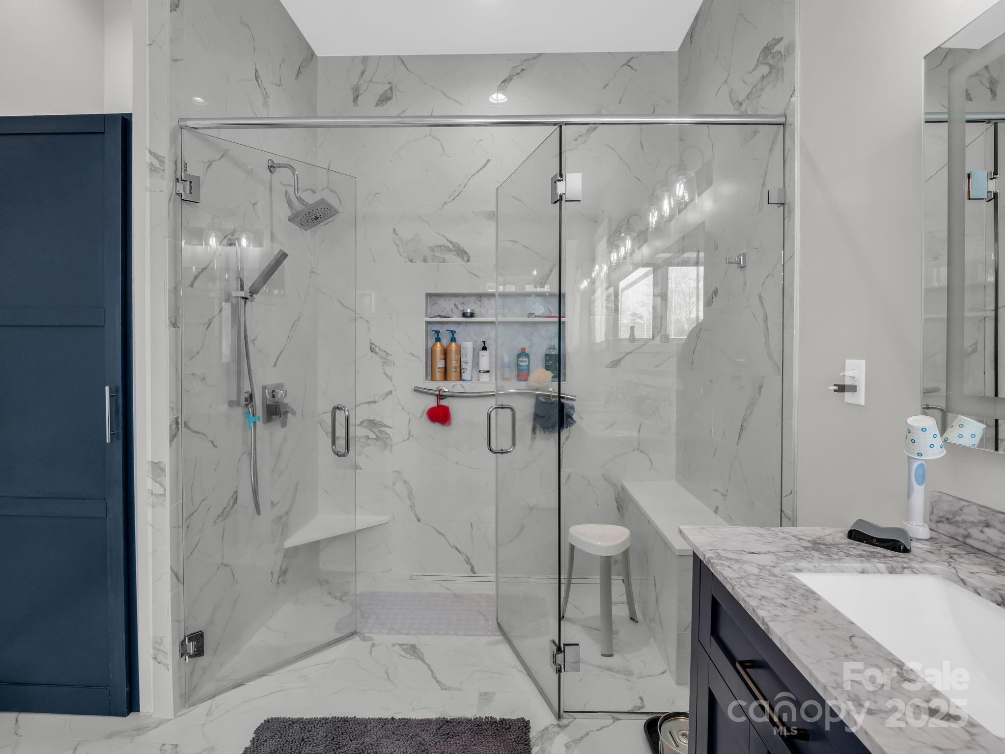 21 Walker Ridge Road Mill Spring, NC 28756 - Photo 21 of 48 a bathroom with a granite countertop shower sink and mirror