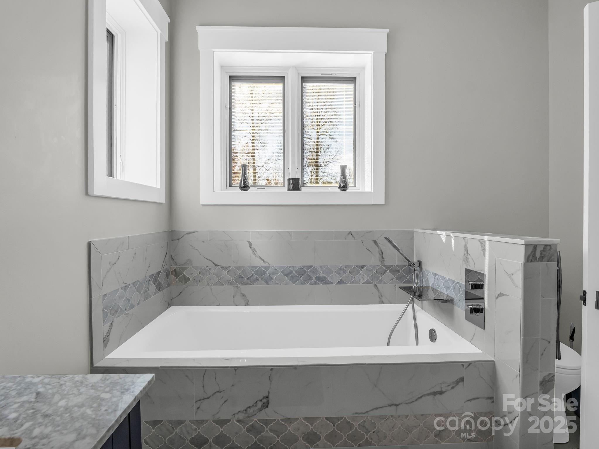 21 Walker Ridge Road Mill Spring, NC 28756 - Photo 22 of 48 a bath tub sitting in a bathroom next to a window