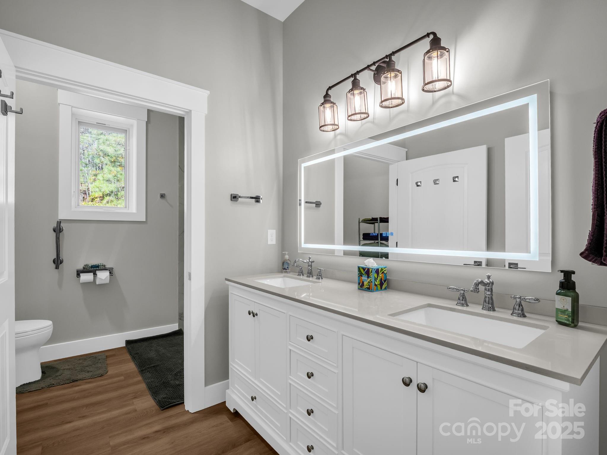 21 Walker Ridge Road Mill Spring, NC 28756 - Photo 30 of 48 a bathroom with a double vanity sink and a mirror