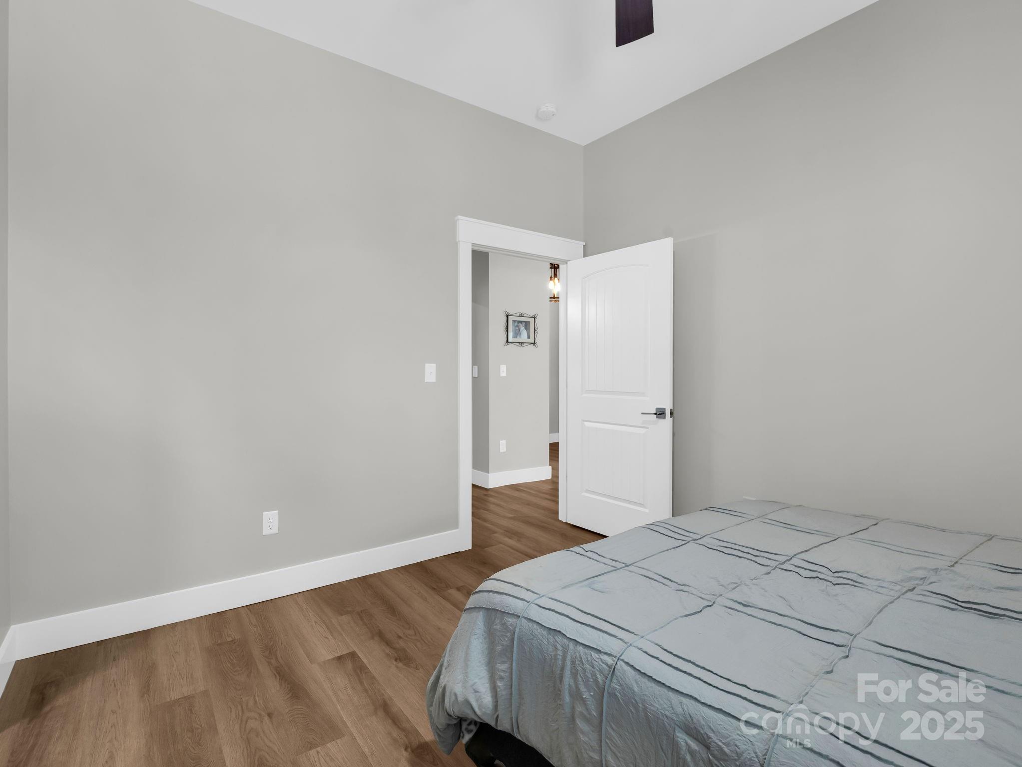 21 Walker Ridge Road Mill Spring, NC 28756 - Photo 33 of 48 a bedroom with a bed and wooden floor