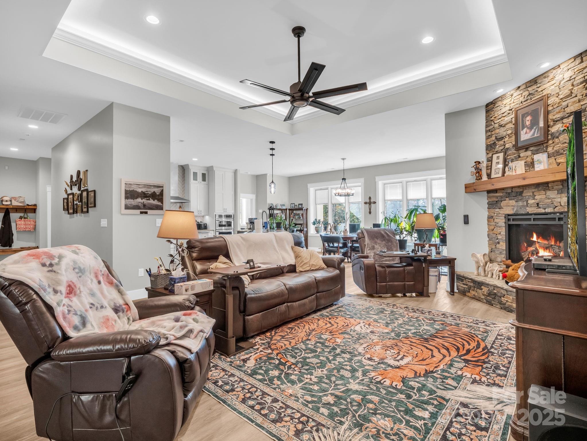 21 Walker Ridge Road Mill Spring, NC 28756 - Photo 5 of 48 a living room with furniture a fireplace and a chandelier