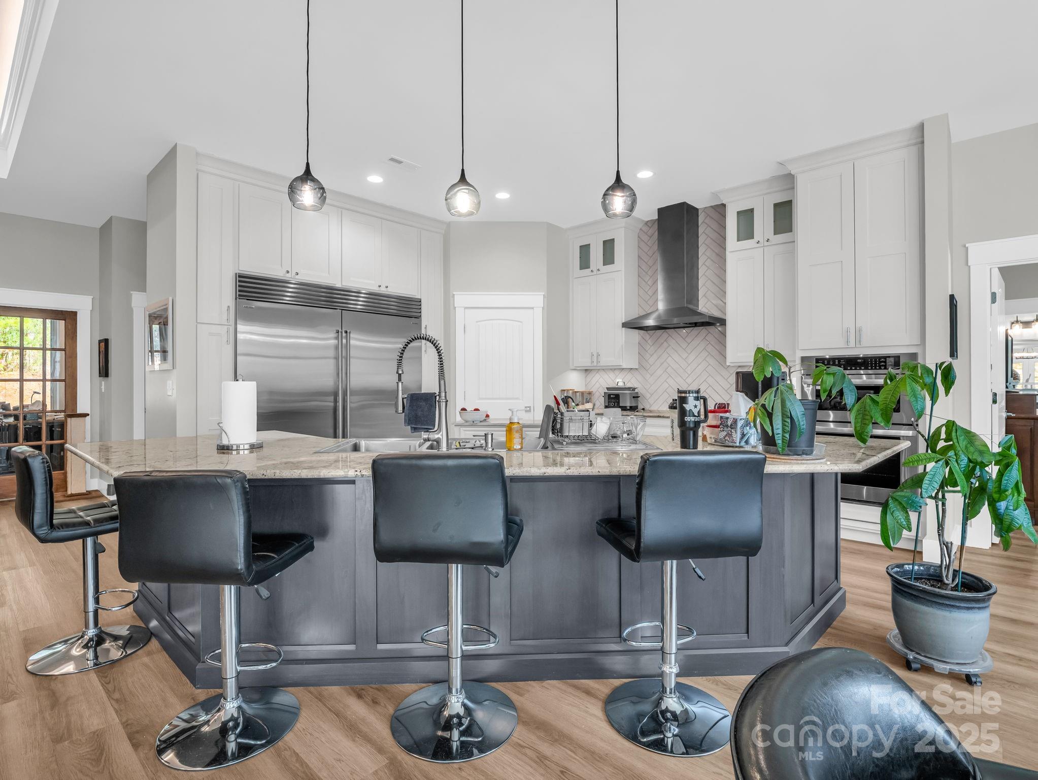 21 Walker Ridge Road Mill Spring, NC 28756 - Photo 9 of 48 a kitchen with stainless steel appliances kitchen island granite countertop a table chairs a sink and cabinets