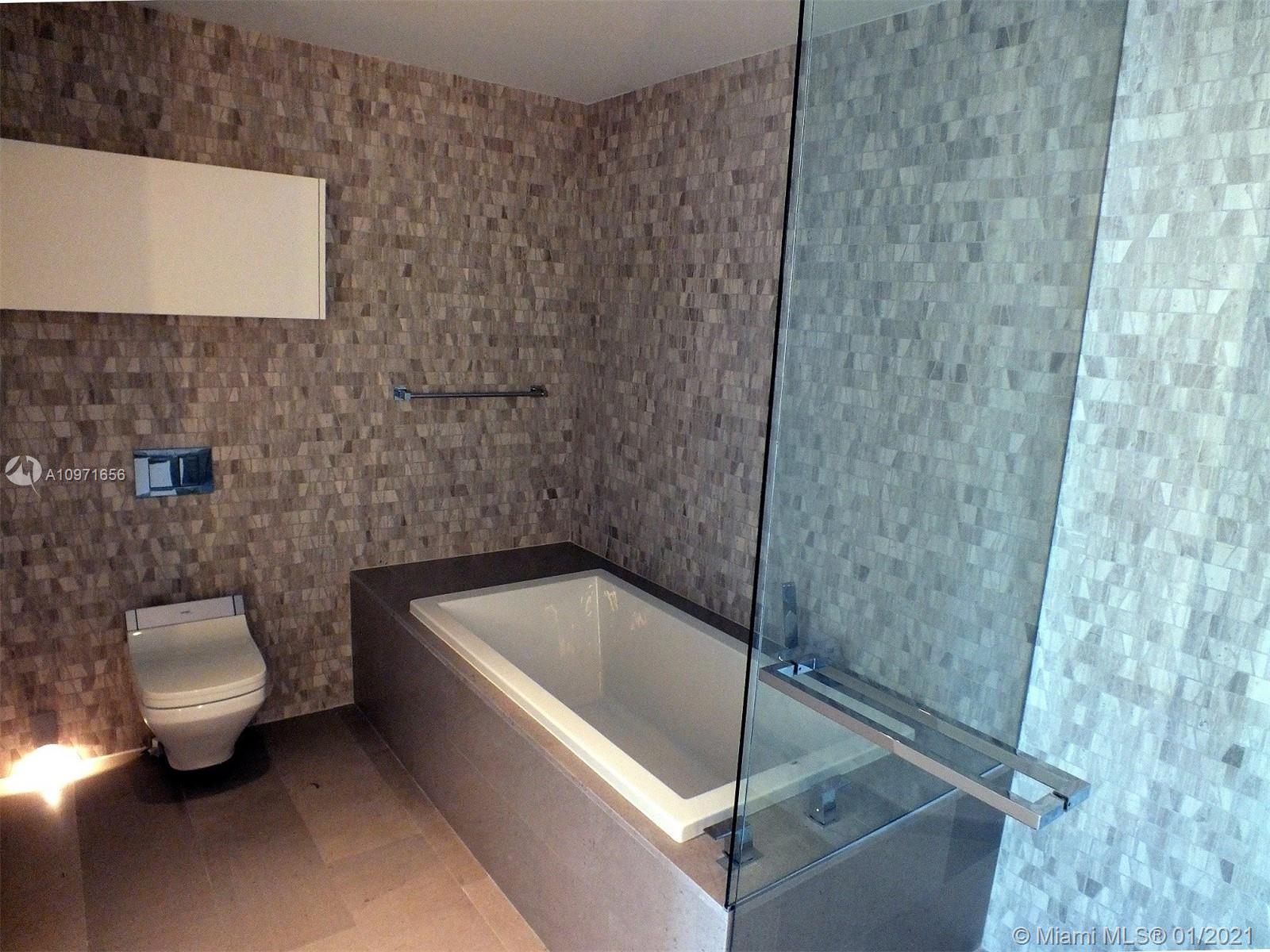 68 Southeast 6th Street, Unit 1010 Miami, FL 33131 - Photo 14 of 43 a bathroom with a toilet and sink