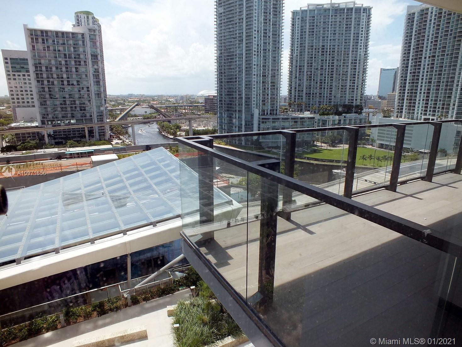 68 Southeast 6th Street, Unit 1010 Miami, FL 33131 - Photo 16 of 43 a balcony with a table and chairs