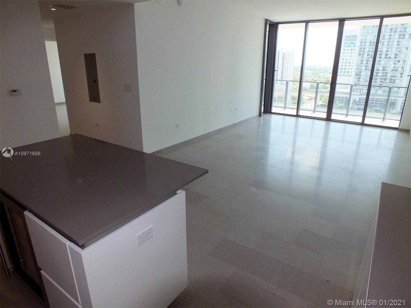 68 Southeast 6th Street, Unit 1010 Miami, FL 33131 - Photo 17 of 43 an empty room with wooden floor and windows