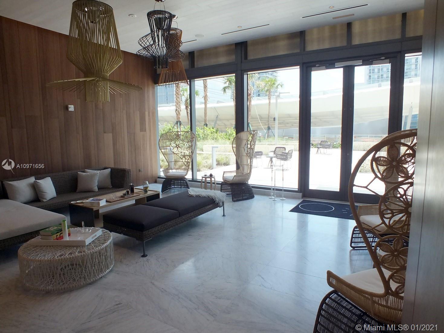 68 Southeast 6th Street, Unit 1010 Miami, FL 33131 - Photo 24 of 43 a living room with furniture and floor to ceiling windows